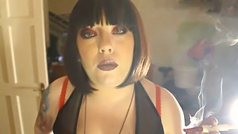 Chubby Dominatrix Tina Smua Puffs On A Unfiltered Cigarette Using A Holder